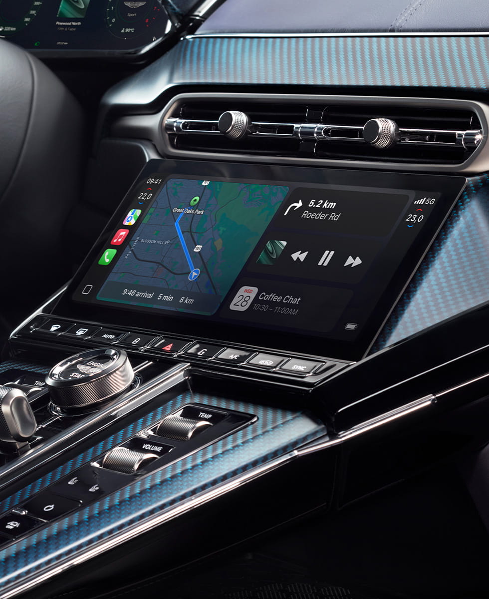 "Close up view highlighting a digital display, carbon fiber trim, and a sophisticated center control panel with tactile buttons and dials"