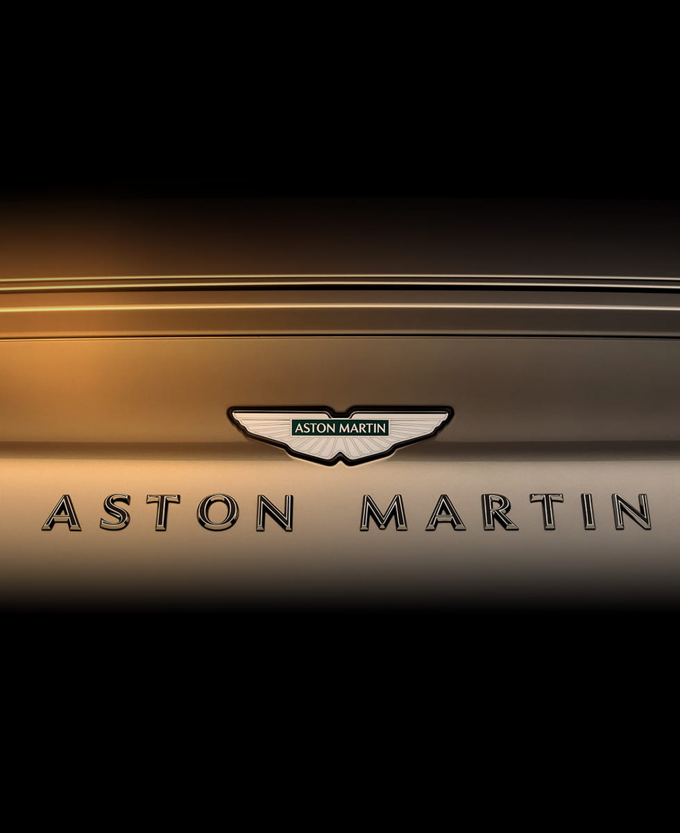 Aston Martin enamel badging spelling out the name Aston Martin is pictured on the rear of DB12 Goldfinger