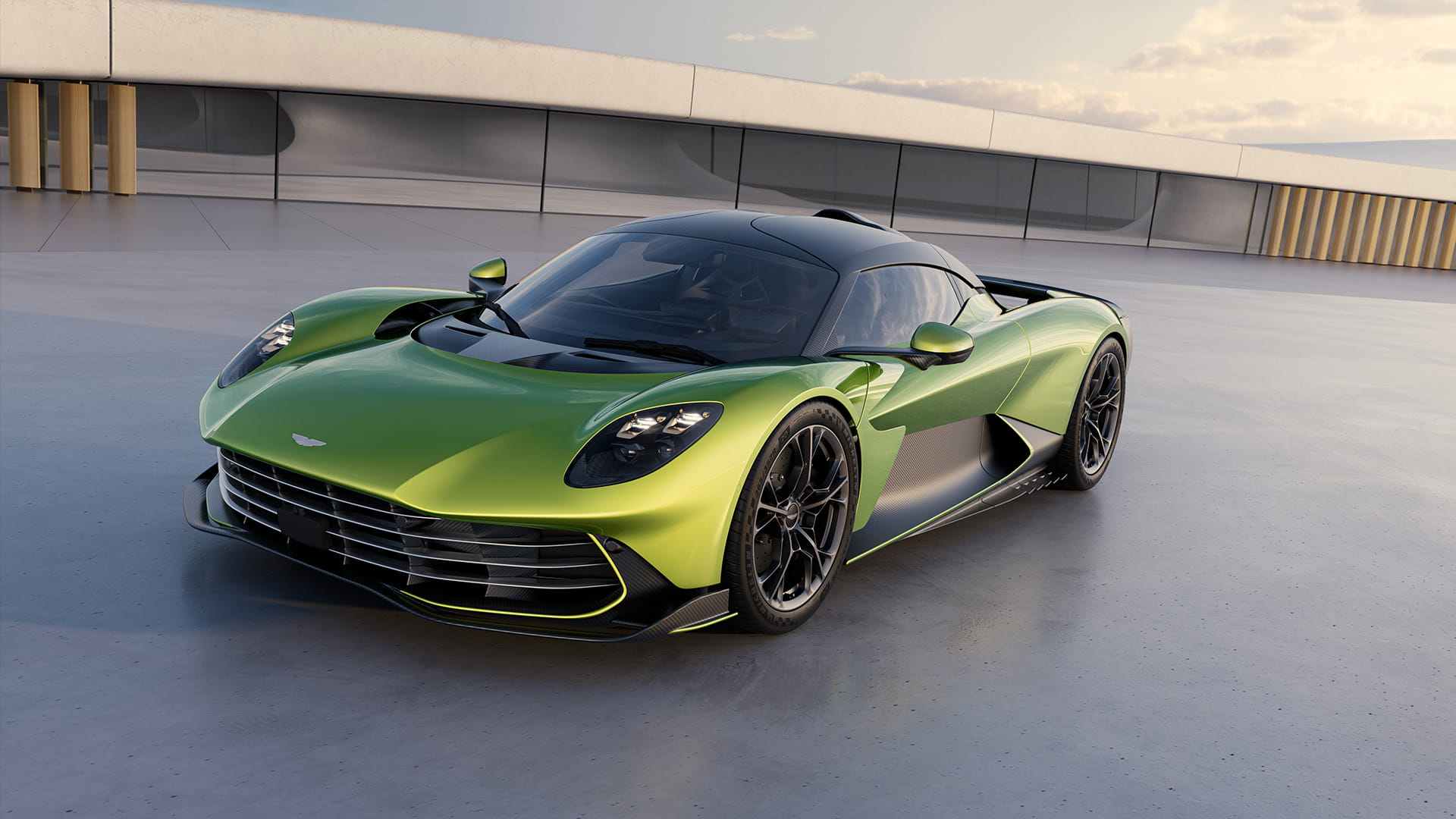 Aston Martin Valhalla in Photon Lime with black detailing, parked on a sleek modern surface under a partly cloudy sky.