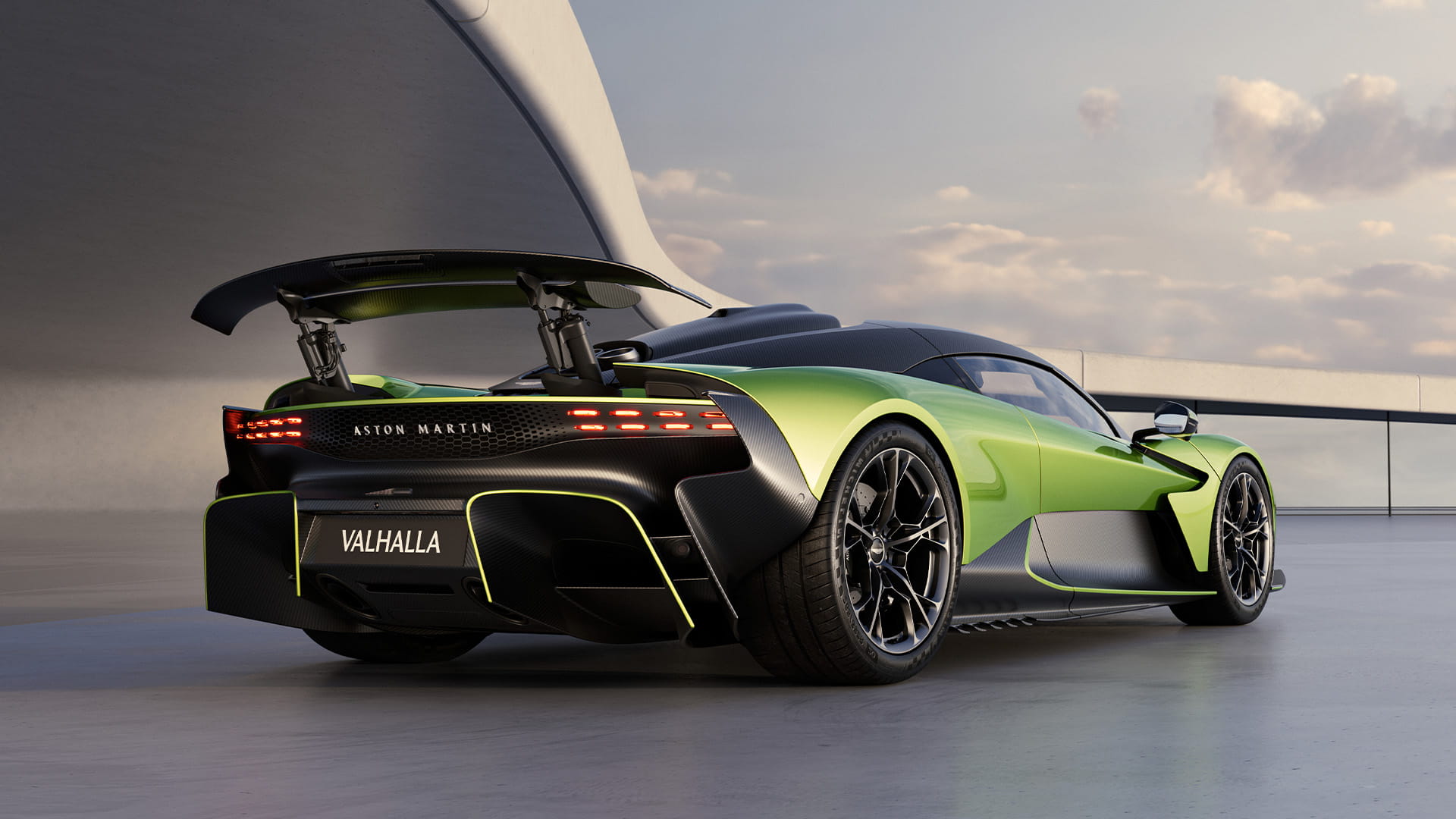 Aston Martin Valhalla in Photon Lime shot from reverse with a raised rear wing and brake lights lit up in red