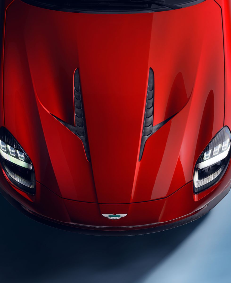 A top-down image shows the red hood of the new Aston Martin Vanquish