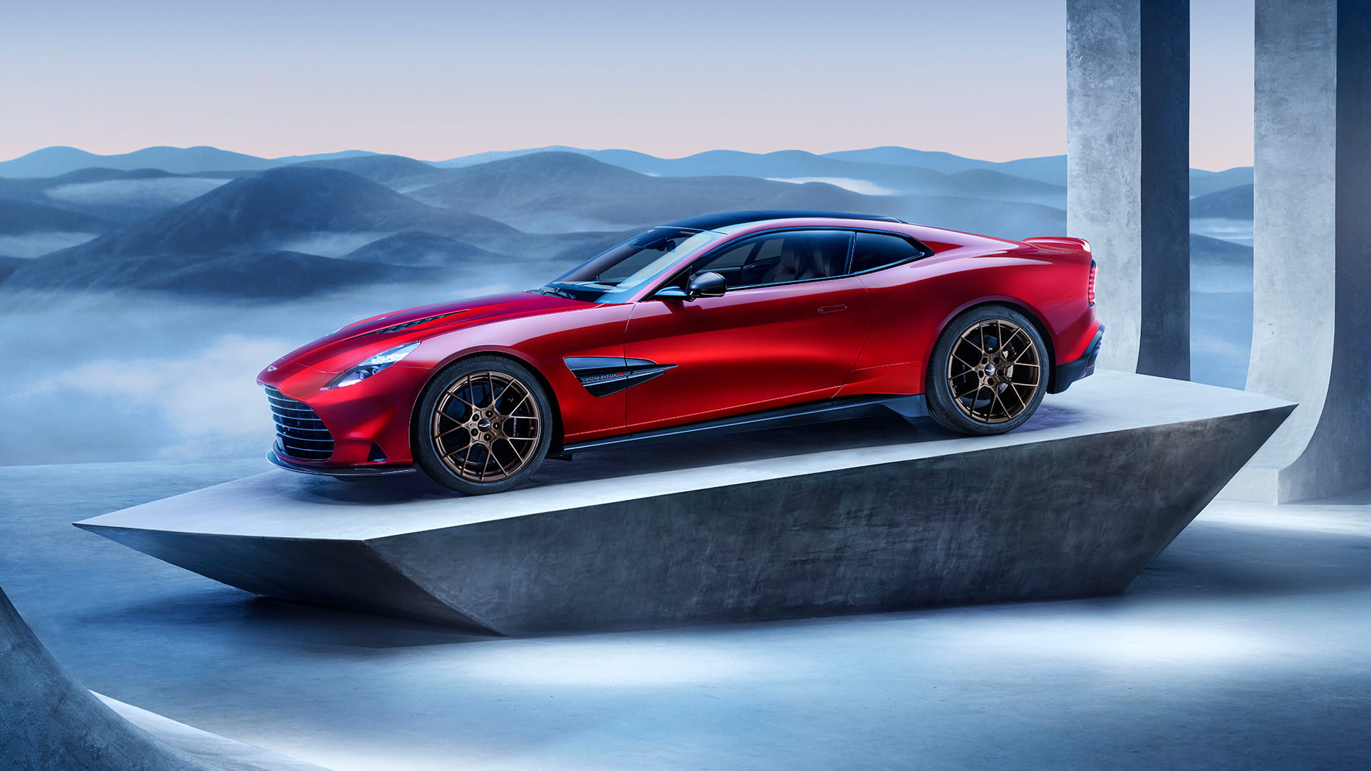 New Aston Martin Vanquish in red pictured on a stone plinth amongst columns
